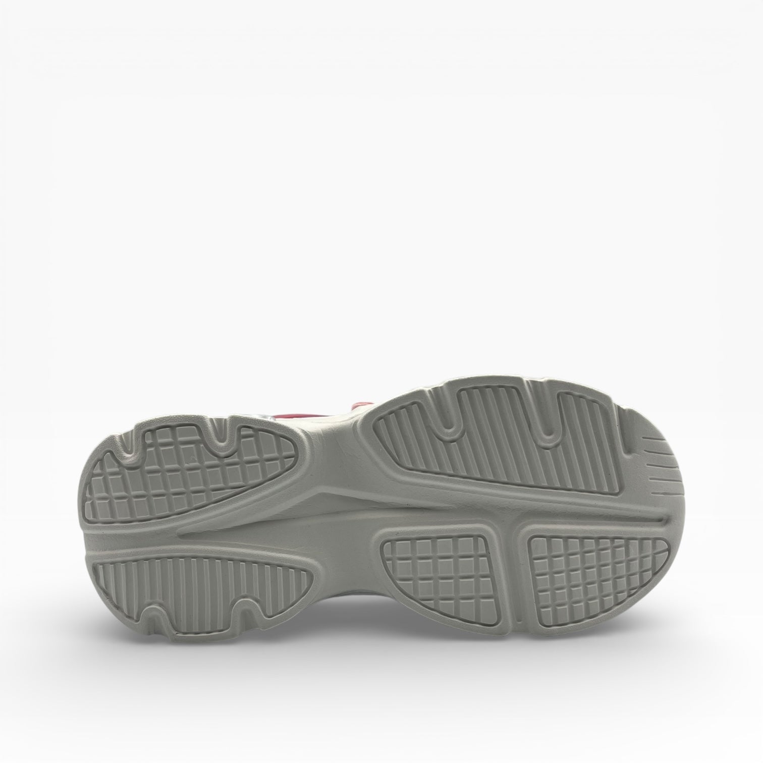 Semelle de basket gris clair en gros plan, LA CHAUSSURERIE, motif antidérapant.